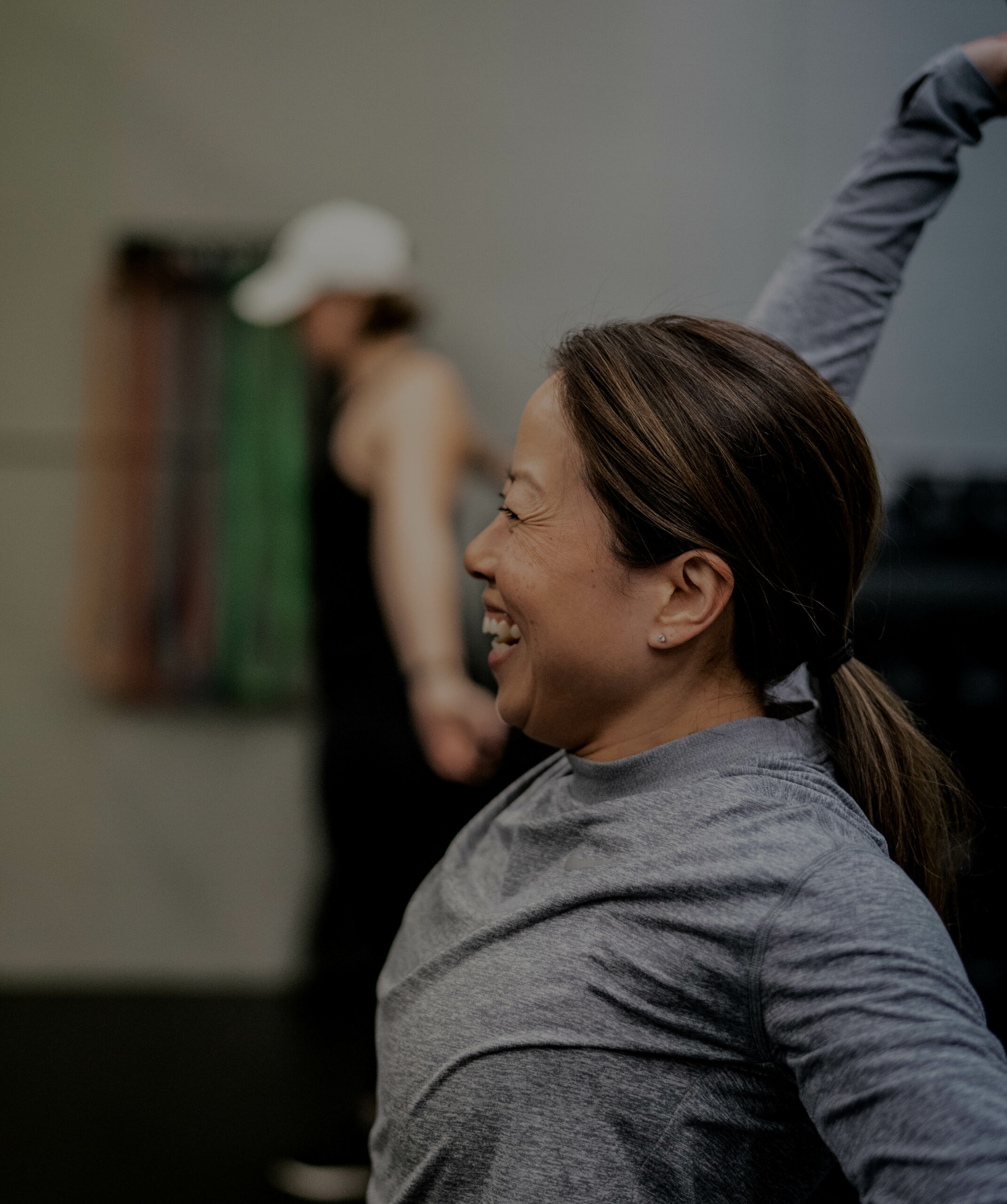 side profile of woman with freckles smiling while doing fitness